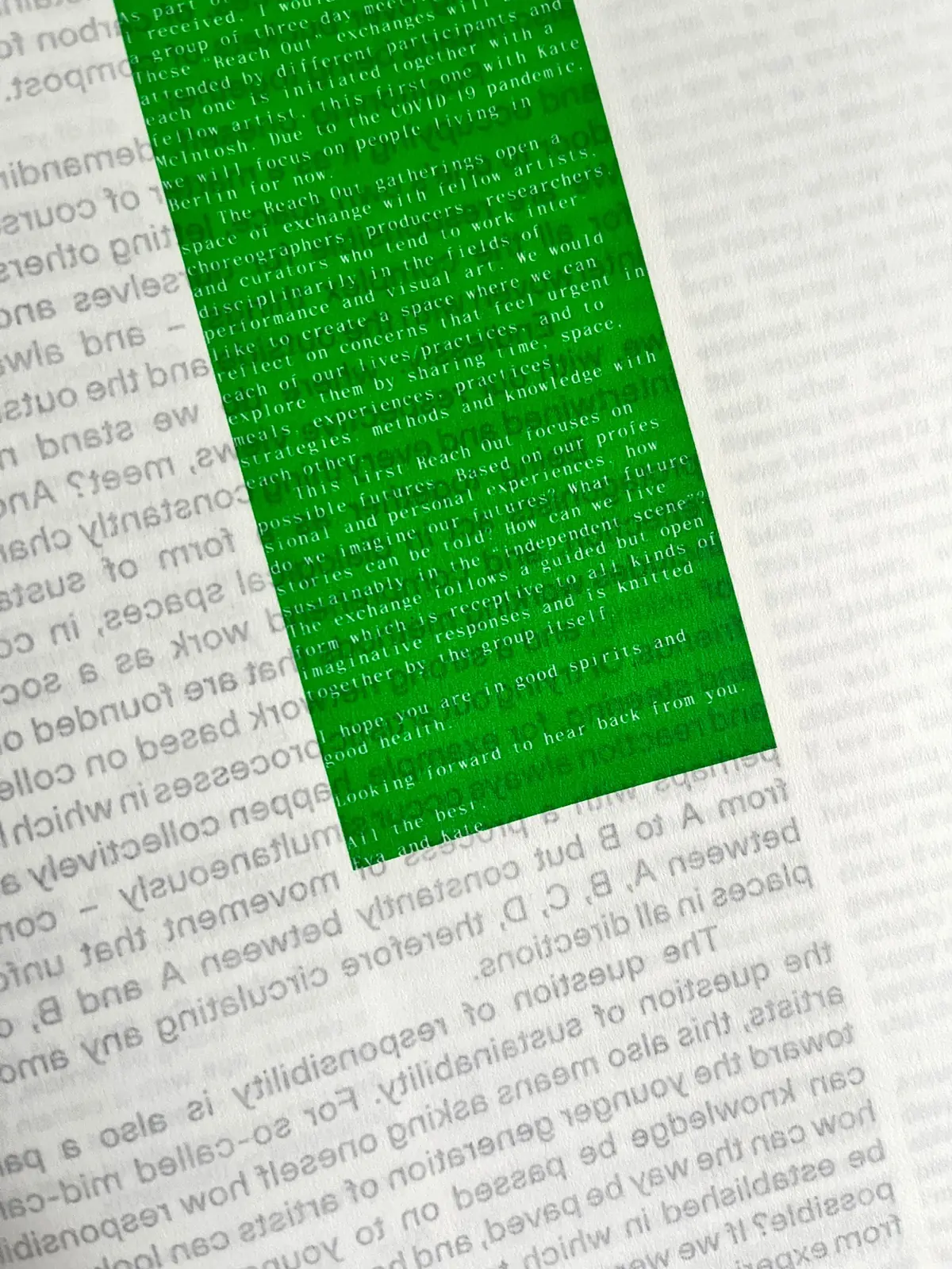 Close-up of a green printed block over small typeset text