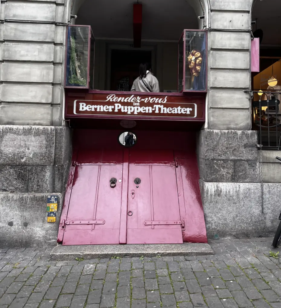 Pink door of the Berner Puppentheater in an arcade